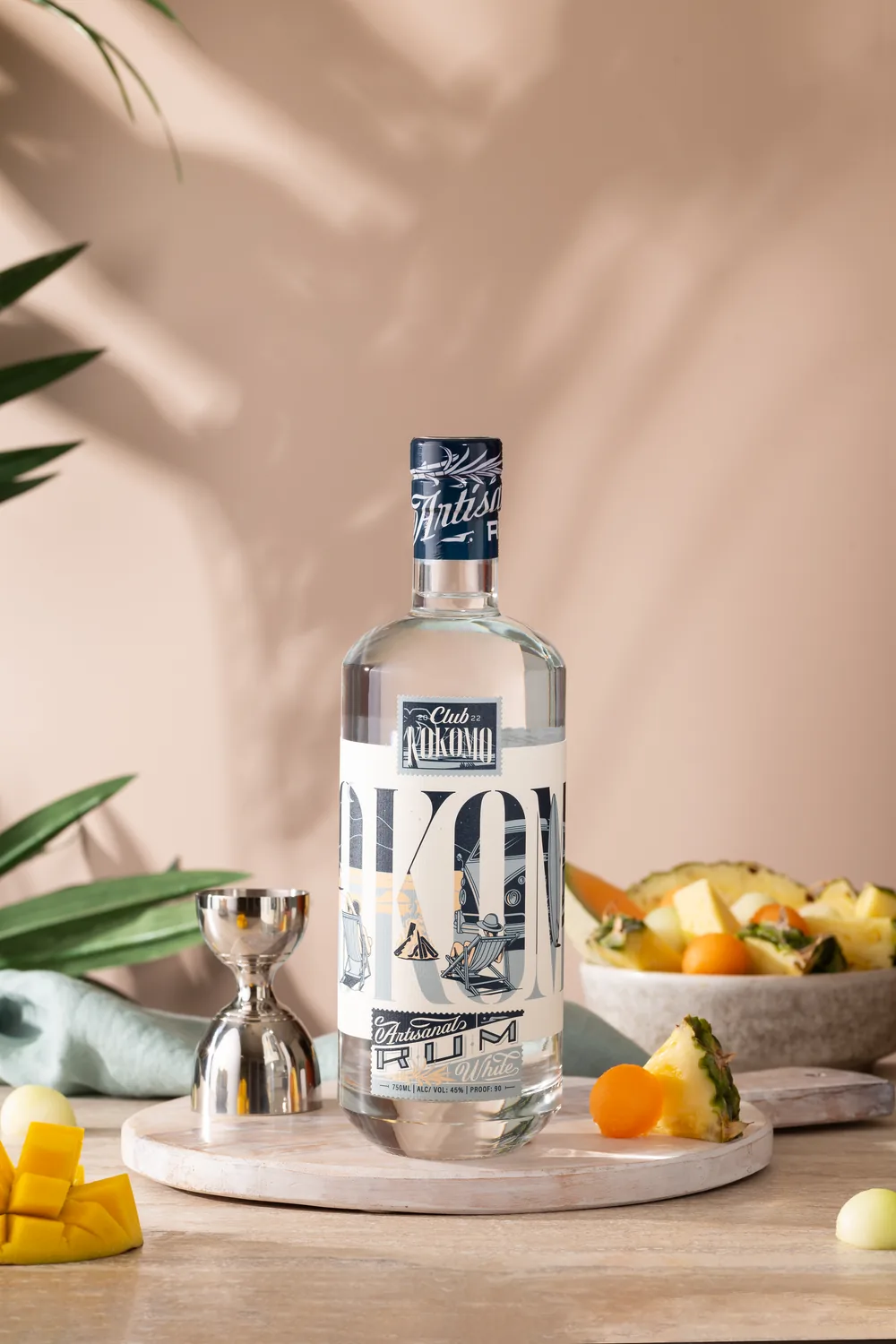 Club Kokomo Artisanal rum with citrus and bar tools in soft natural light